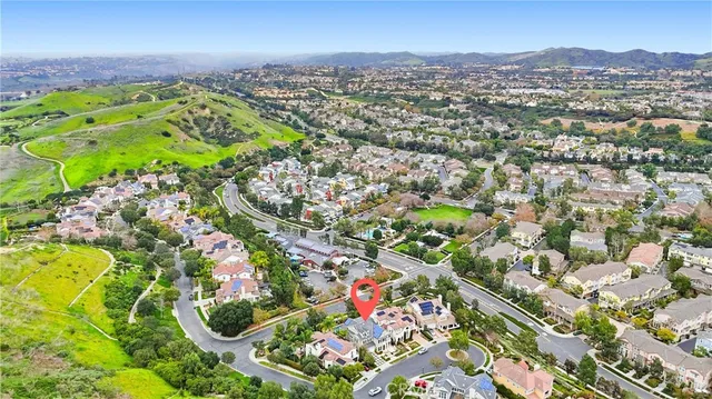 a view of a lush green hillside and houses
