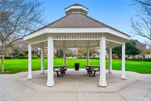 a view of a house with a swimming pool and sitting area