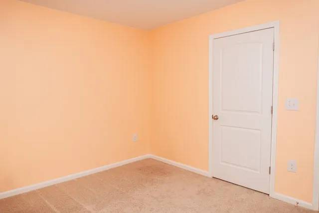 a bathroom with a granite countertop sink toilet and a mirror