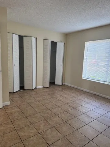 a spacious bathroom with a tub sink and mirror