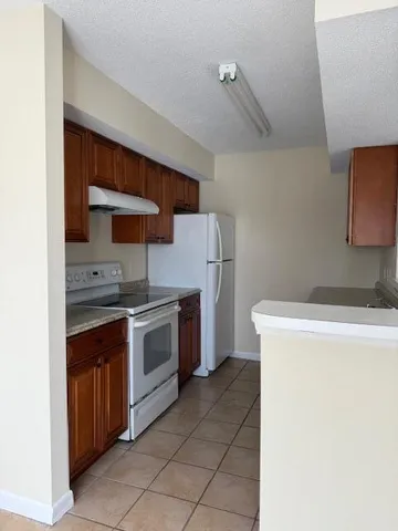 a spacious bathroom with a granite countertop sink and a mirror