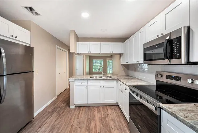a kitchen with a sink stove and refrigerator