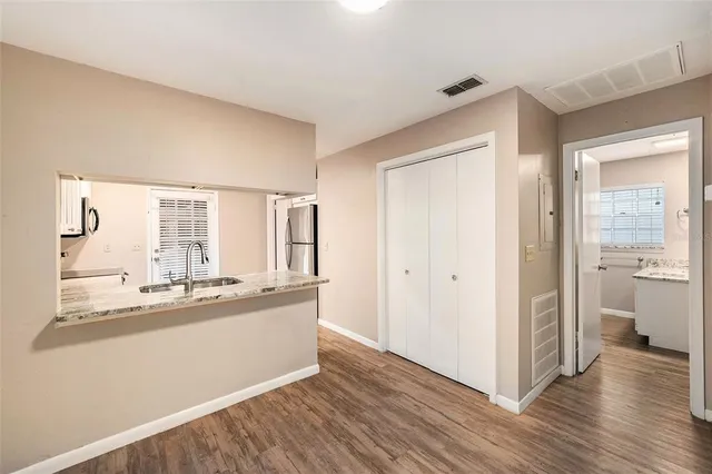 a kitchen with granite countertop a refrigerator and a sink