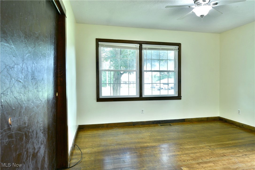 1141 Howell Road East Palestine, OH 44413 - Photo 27 of 41 Unfurnished room featuring wood finished floors and a ceiling fan