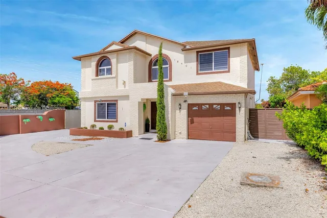 a front view of a house with a yard and a garage
