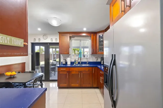a kitchen with stainless steel appliances a refrigerator and a stove