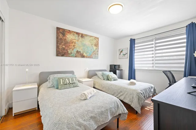 a bedroom with a bed and a desk