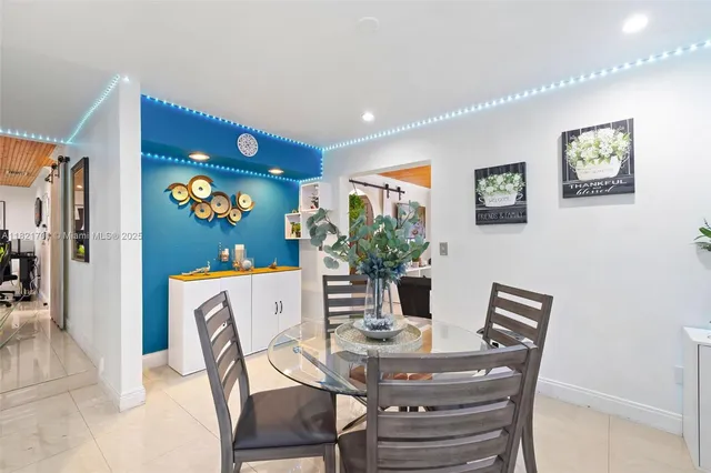 a view of a dining room with furniture and a potted plant