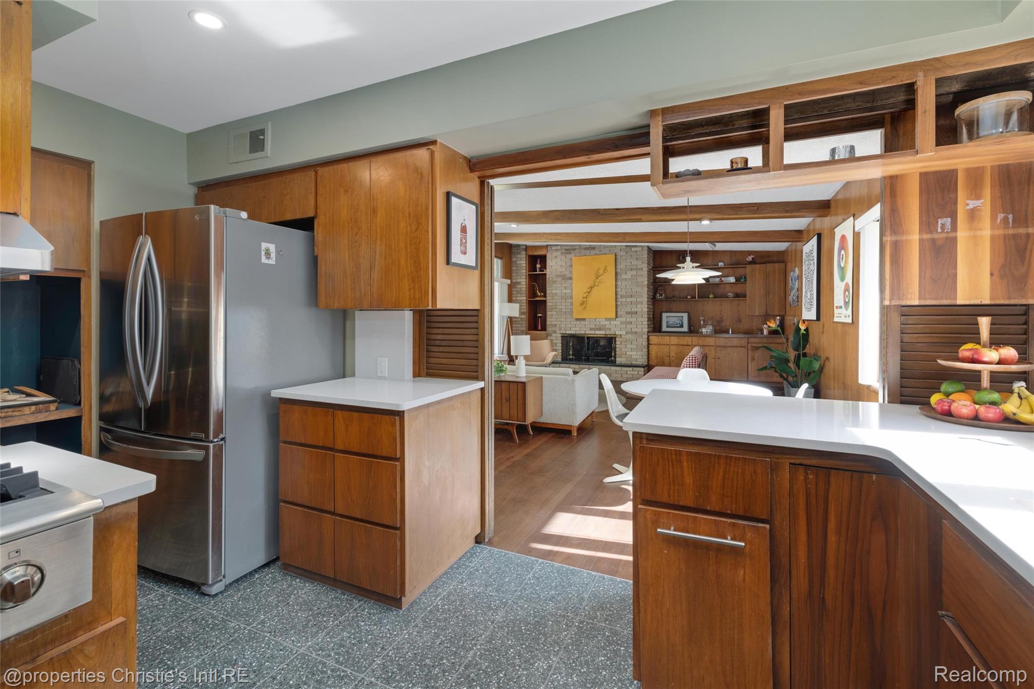 2771 West Seven Mile Road Detroit, MI 48221 - Photo 26 of 57 Kitchen featuring wood-grain cabinetry, light-toned countertops, and a stainless steel refrigerator