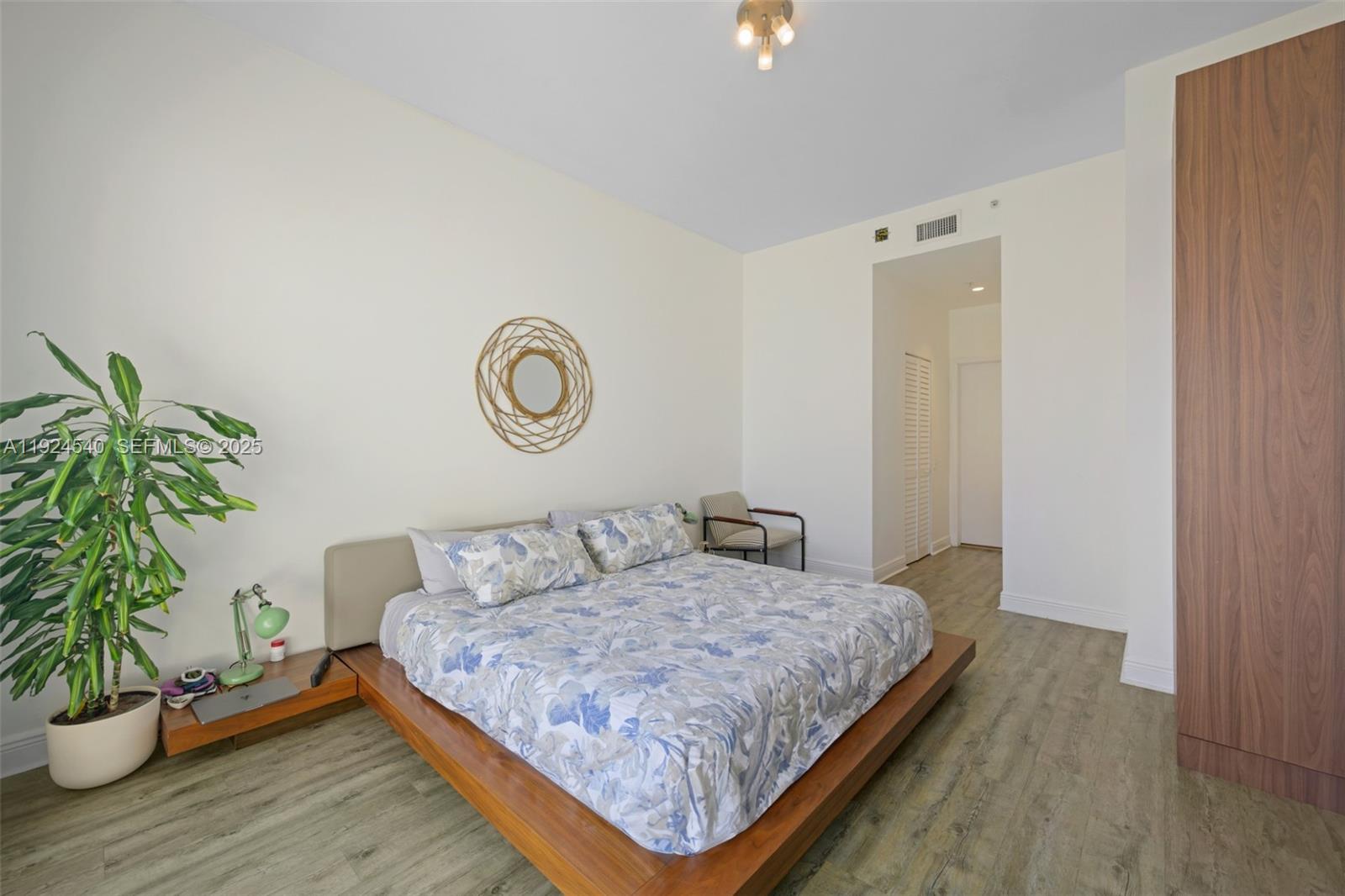 888 Brickell Key Drive, Unit 2909 Miami, FL 33131 - Photo 12 of 24 a bedroom with a bed and a potted plant