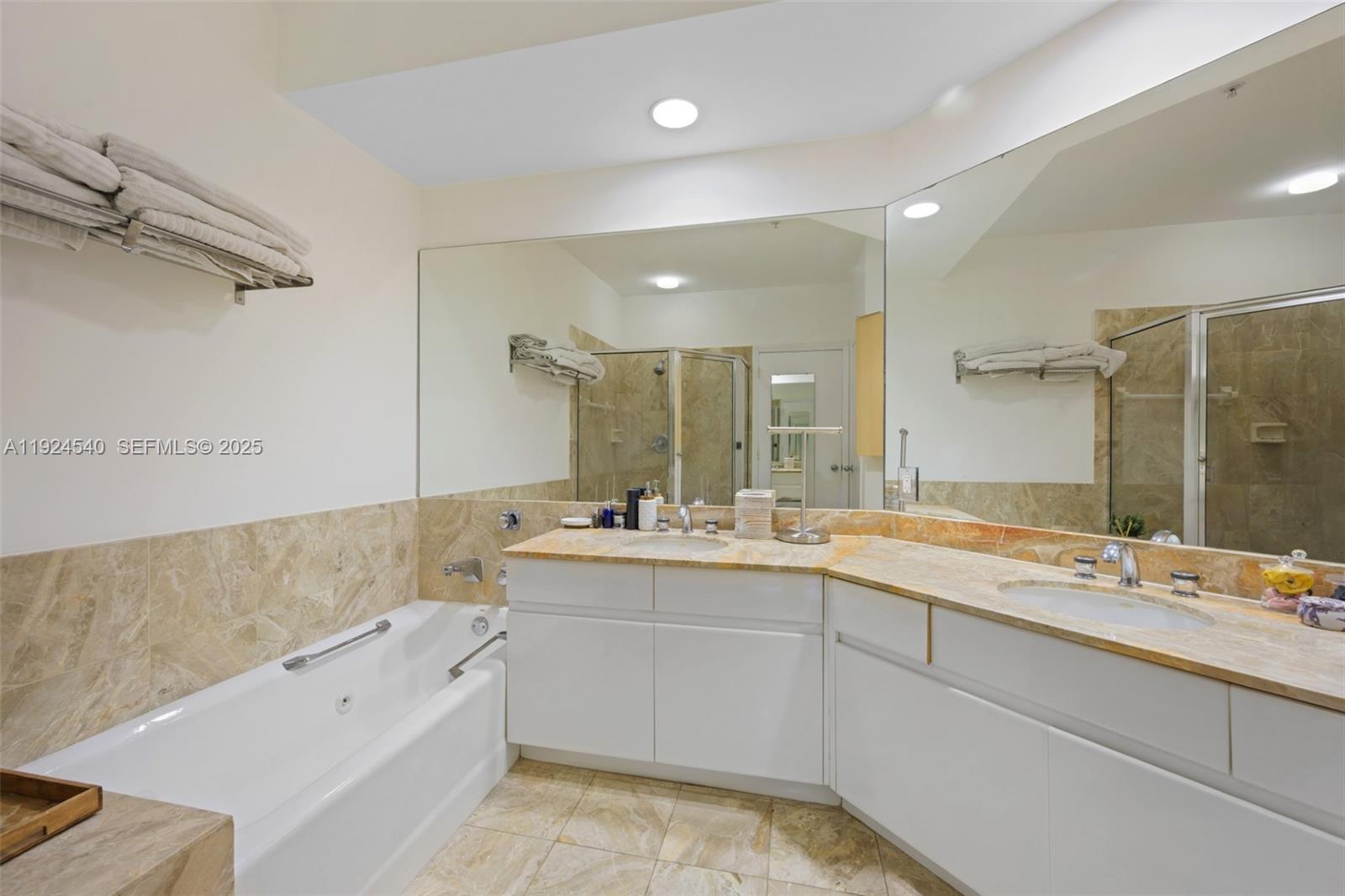 888 Brickell Key Drive, Unit 2909 Miami, FL 33131 - Photo 15 of 24 a bathroom with a tub sink shower and mirror