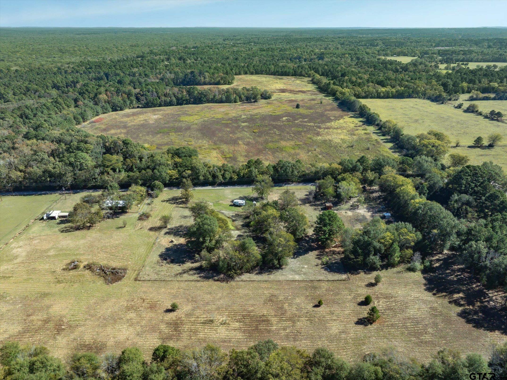 21151 C R 4106 Lindale, TX 75771 - Photo 12 of 12 a view of a lake with a mountain and trees