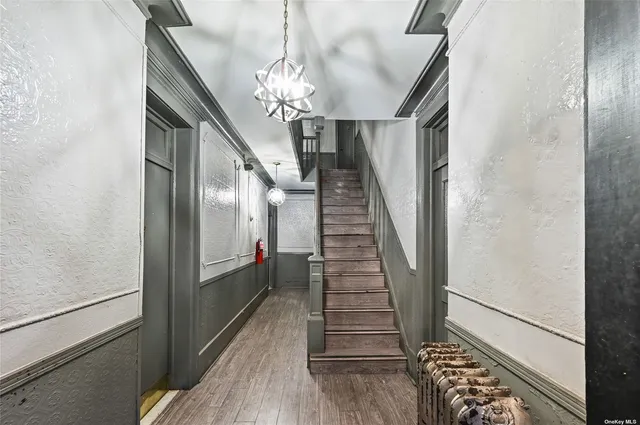a view of entryway and hall with wooden floor