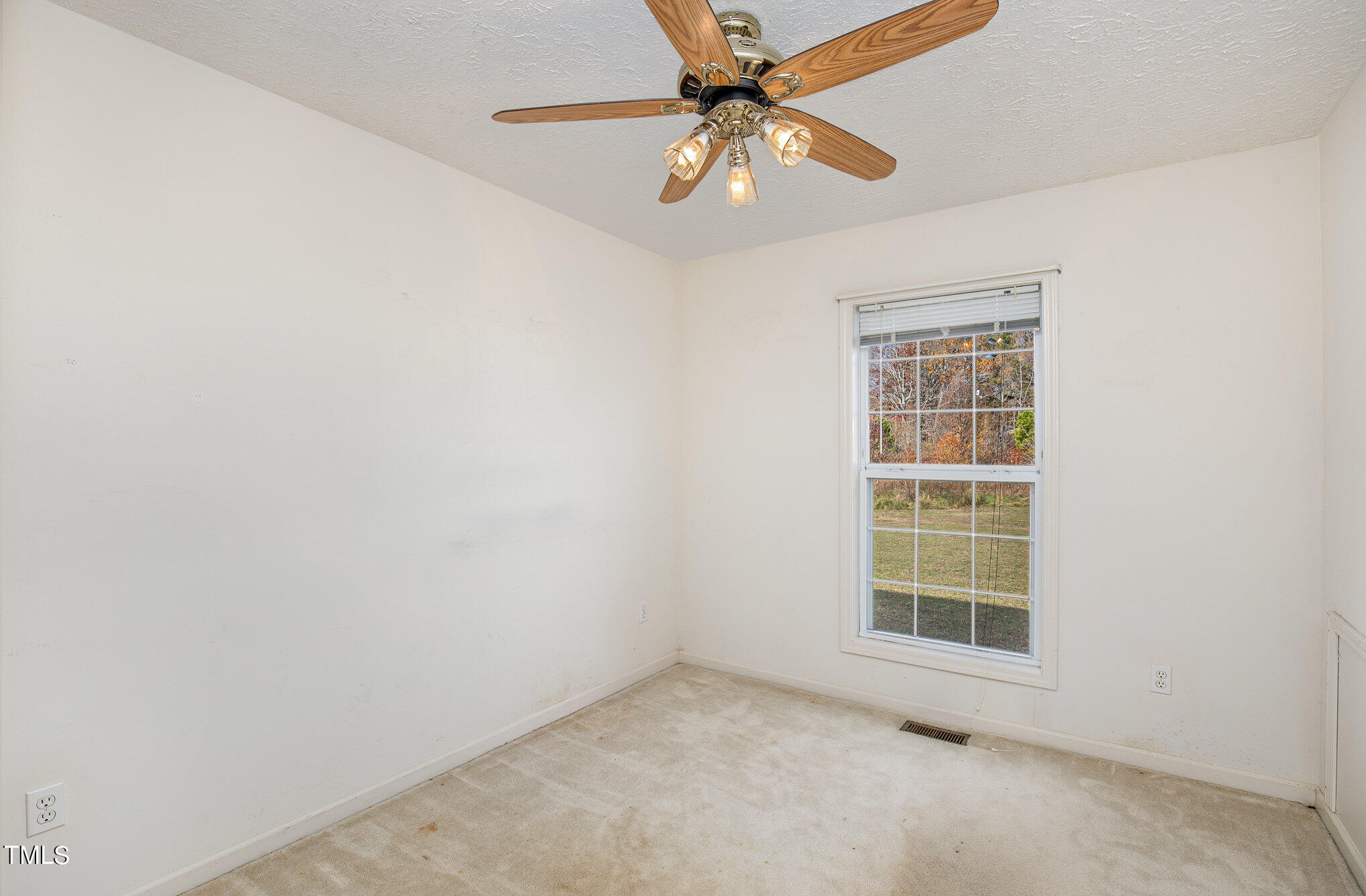 424 Henry Baker Road Zebulon, NC 27597 - Photo 15 of 26 an empty room with windows and fan