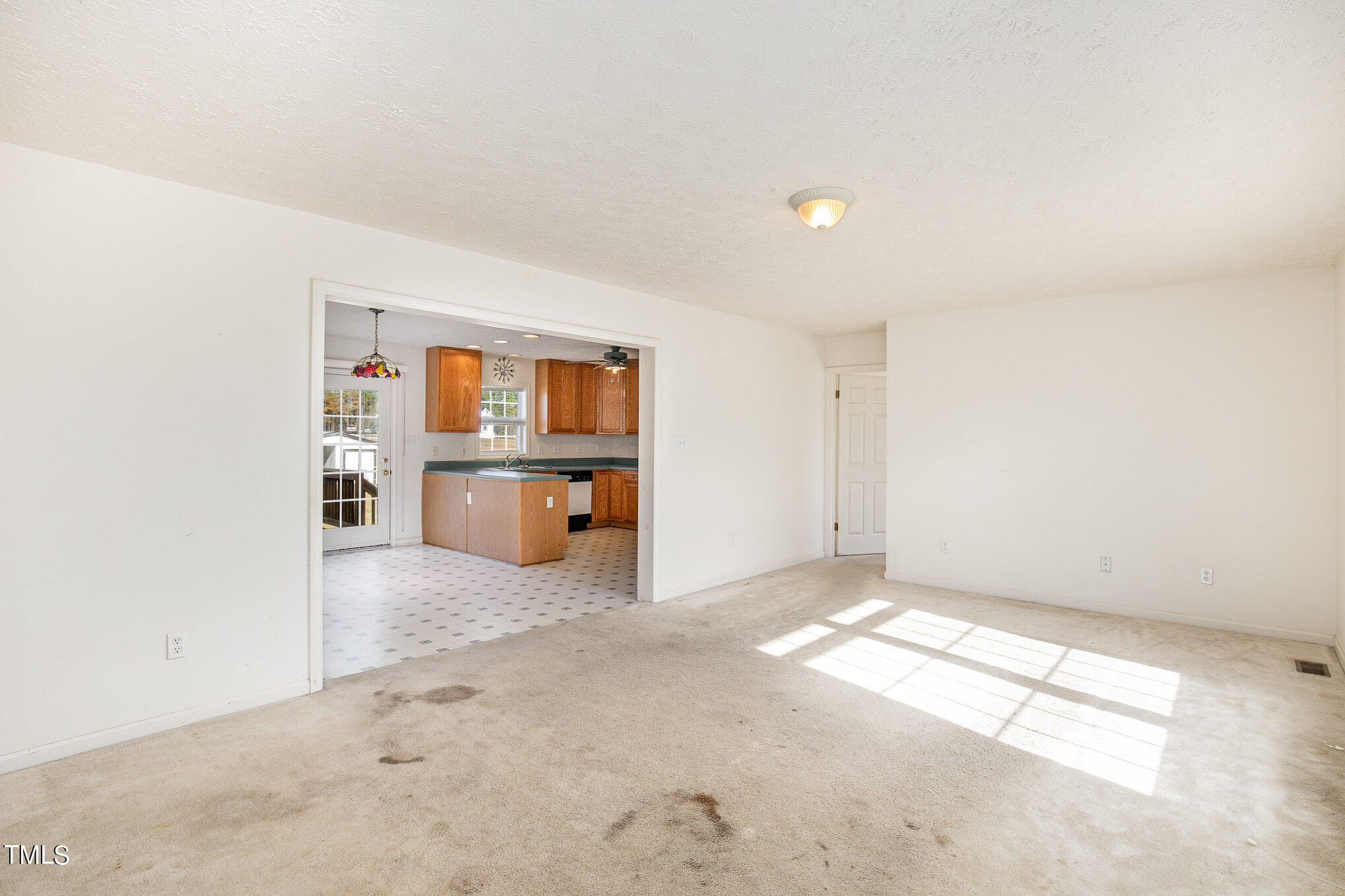 424 Henry Baker Road Zebulon, NC 27597 - Photo 6 of 26 an empty room with windows