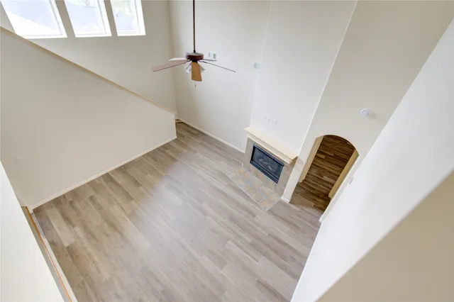 a view of staircase with white walls and railing