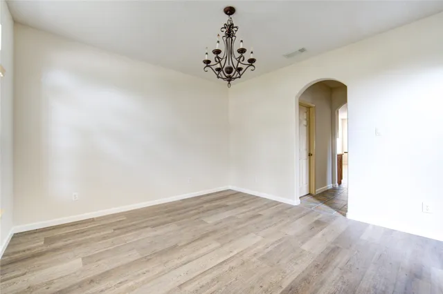 a view of a chandelier fan and wooden floor