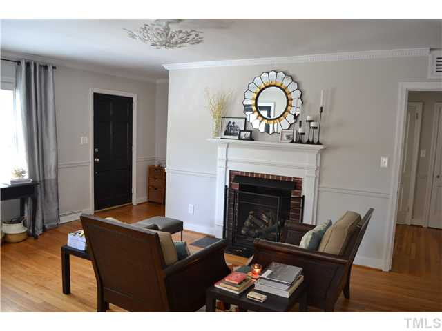 309 Glascock Street Raleigh, NC 27604 - Photo 4 of 23 enter into your formal living room with fireplace, hardwood floors and cool vintage ceiling light