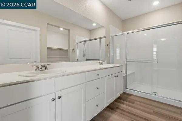 a bathroom with a toilet a sink and shower