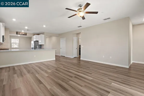 a view of an empty room with wooden floor