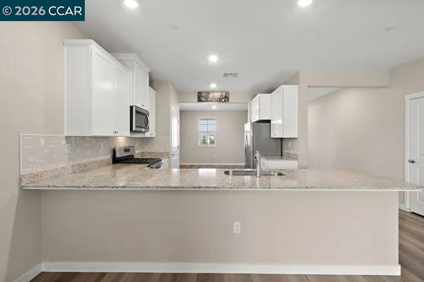 a kitchen with stainless steel appliances granite countertop a stove and a sink