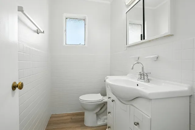 a bathroom with a sink toilet and a mirror