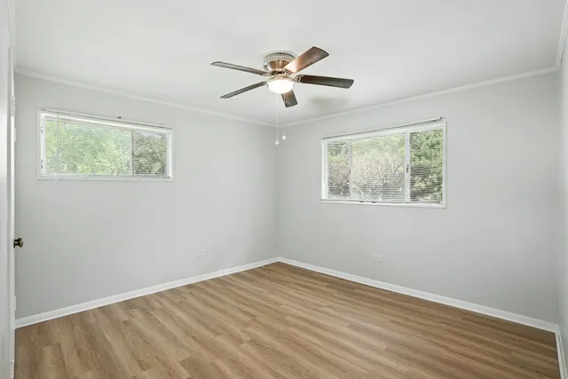 a view of empty room with wooden floor