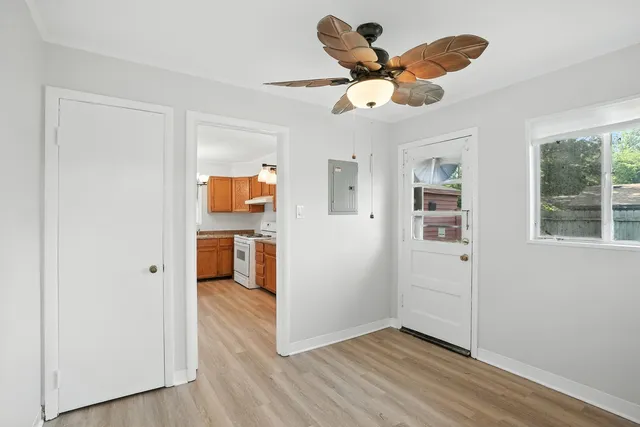a view of a livingroom with a ceiling fan & hardwood floor