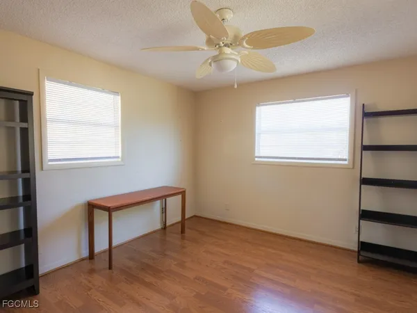 a view of room with window and wooden floor