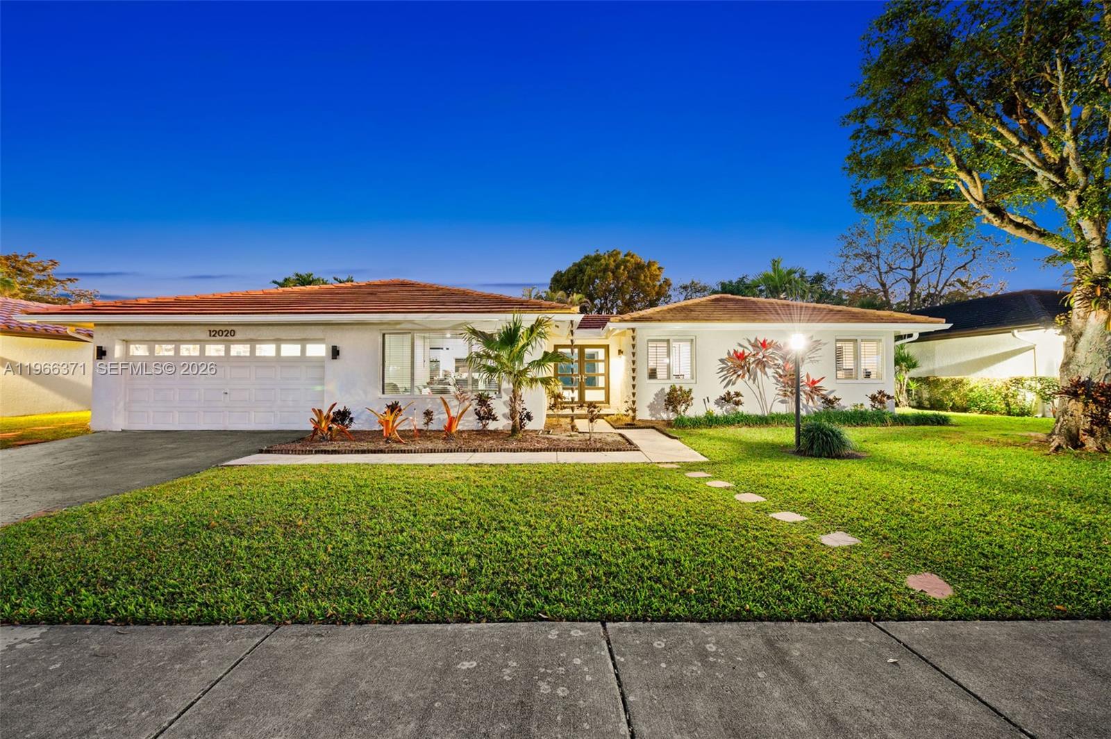 a front view of a house with garden