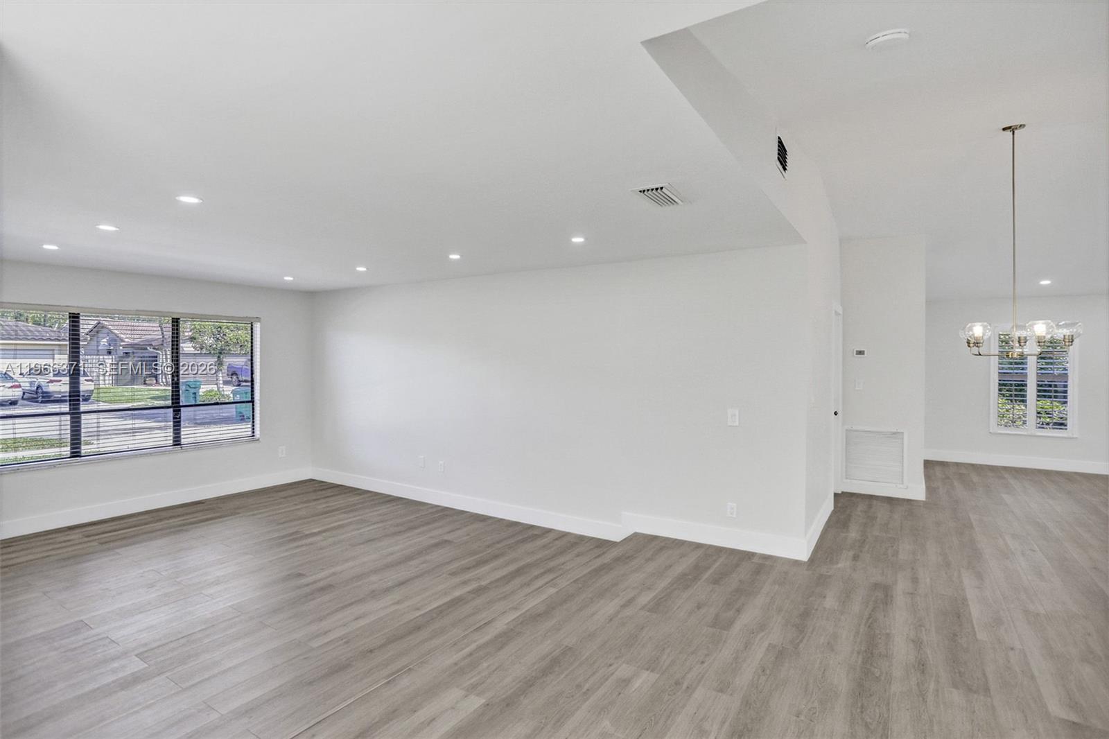12020 Southwest 93rd Street Miami, FL 33186 - Photo 14 of 42 an empty room with wooden floor and windows