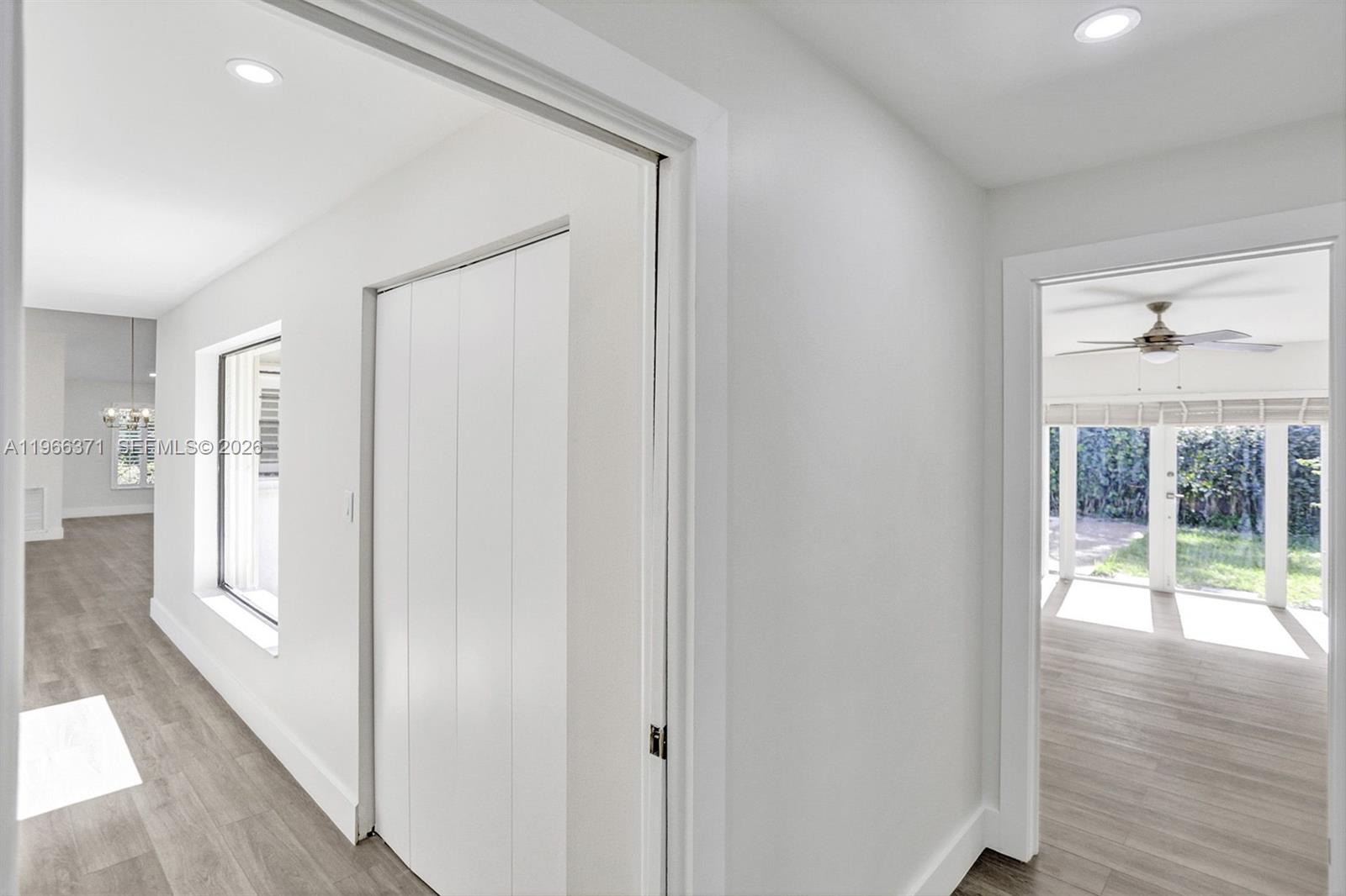 12020 Southwest 93rd Street Miami, FL 33186 - Photo 16 of 42 a view of a hallway with wooden floor and a living room