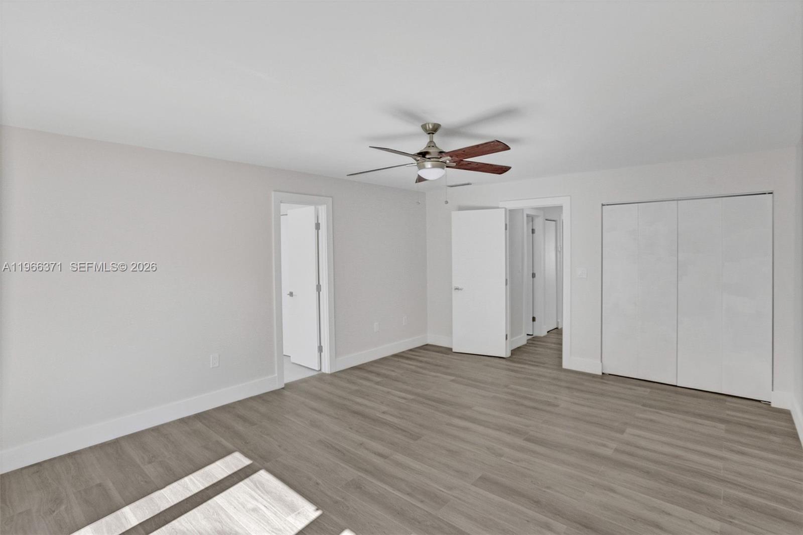 12020 Southwest 93rd Street Miami, FL 33186 - Photo 19 of 42 a view of an empty room with wooden floor