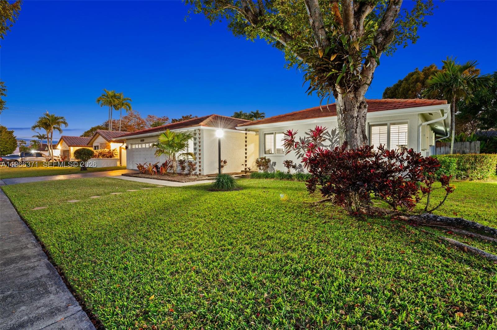 12020 Southwest 93rd Street Miami, FL 33186 - Photo 2 of 42 a front view of a house with garden
