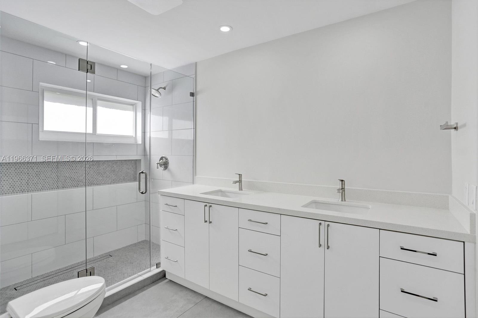 12020 Southwest 93rd Street Miami, FL 33186 - Photo 21 of 42 a bathroom with a sink a toilet and shower