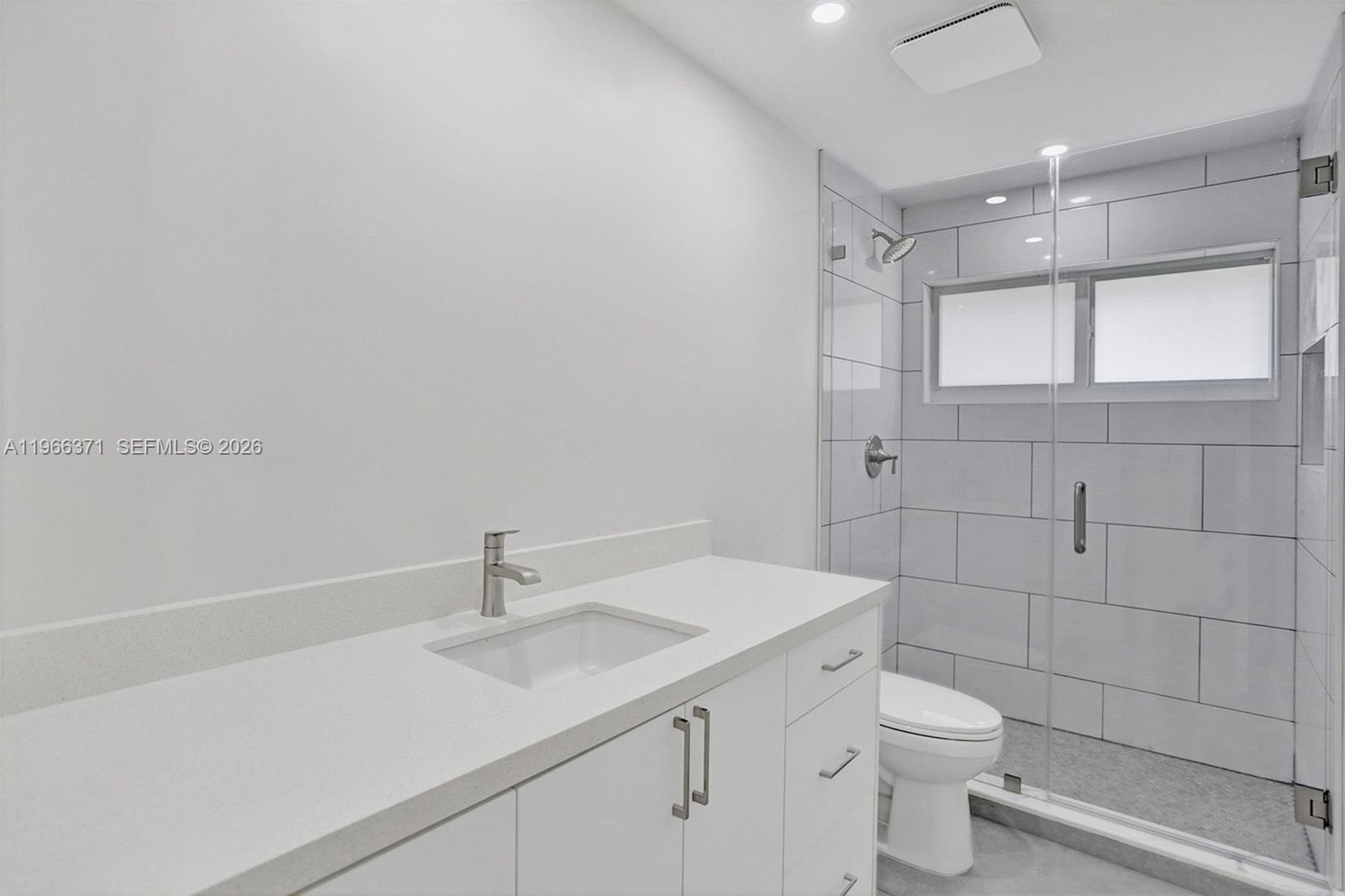 12020 Southwest 93rd Street Miami, FL 33186 - Photo 22 of 42 a bathroom with a sink toilet and vanity