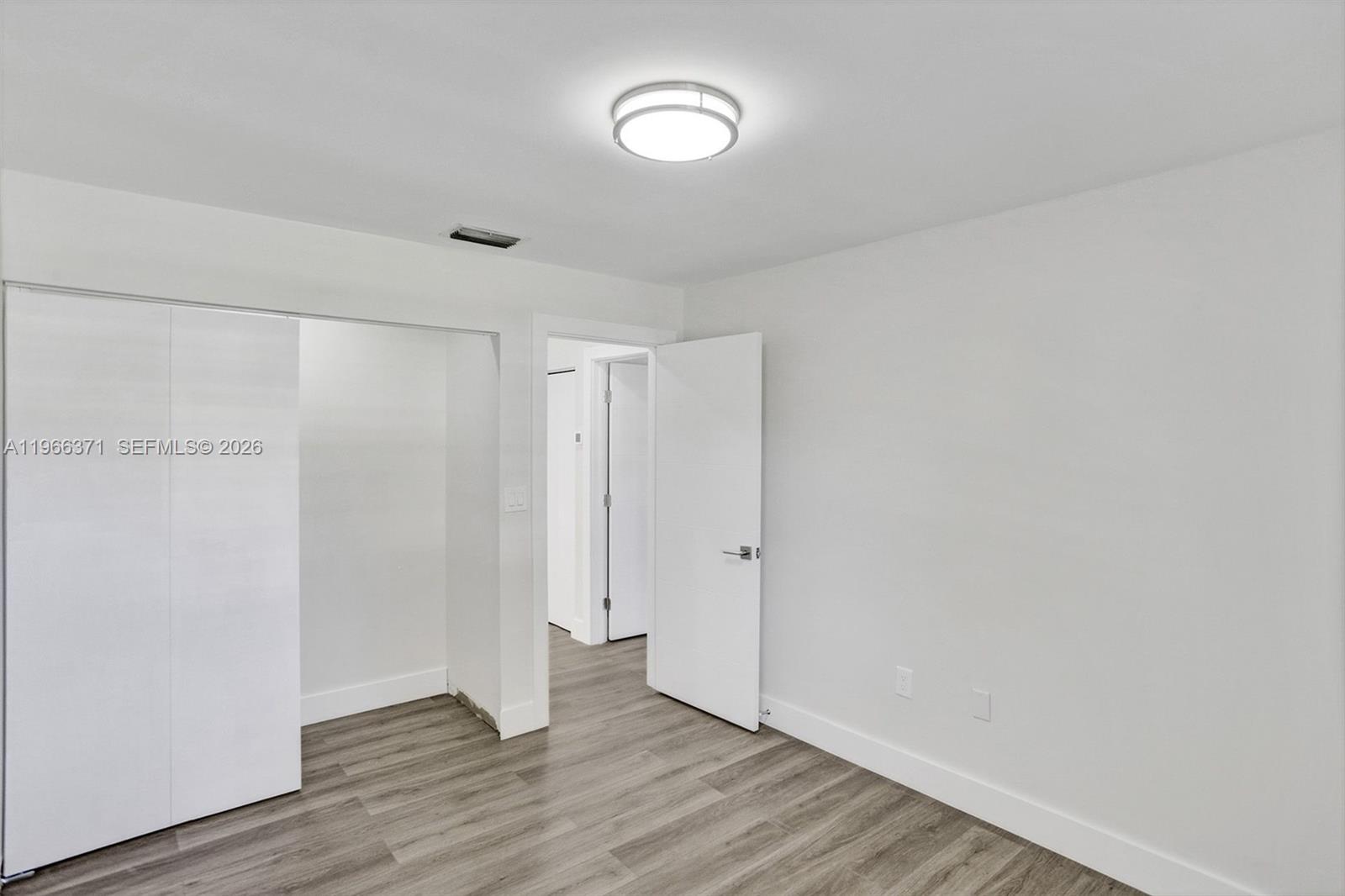 12020 Southwest 93rd Street Miami, FL 33186 - Photo 30 of 42 a view of an empty room with wooden floor