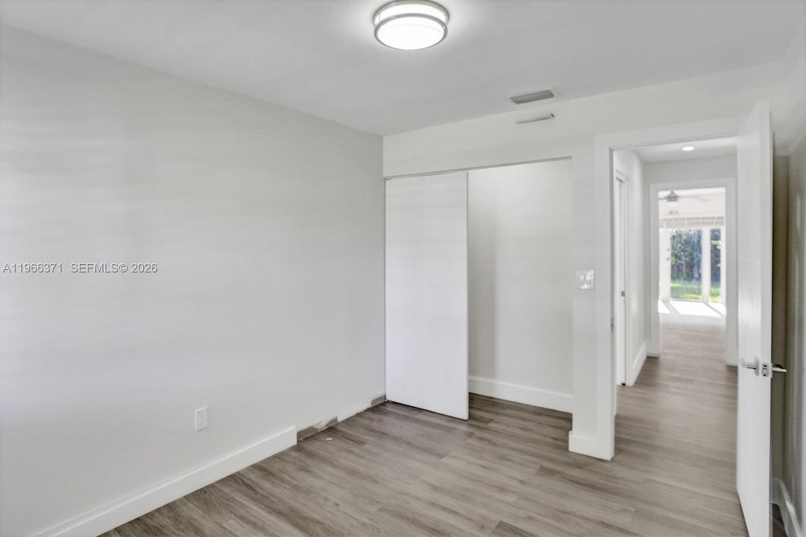 12020 Southwest 93rd Street Miami, FL 33186 - Photo 31 of 42 a view of an empty room with wooden floor