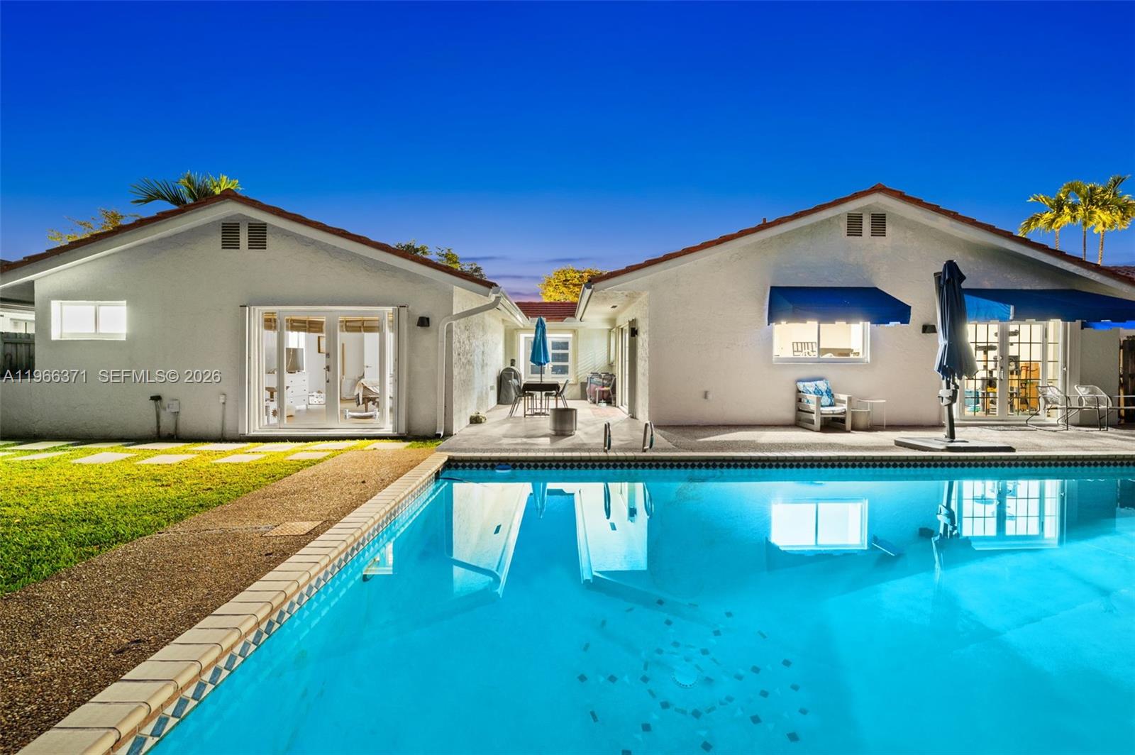 12020 Southwest 93rd Street Miami, FL 33186 - Photo 37 of 42 a front view of a house with swimming pool having outdoor seating