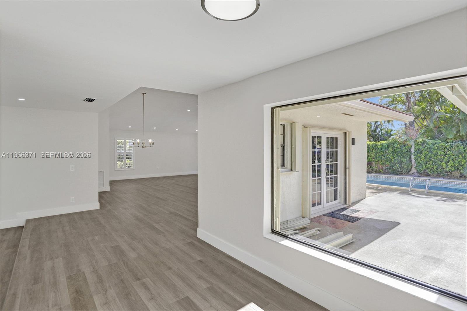 12020 Southwest 93rd Street Miami, FL 33186 - Photo 4 of 42 a view of a room with wooden floor and window