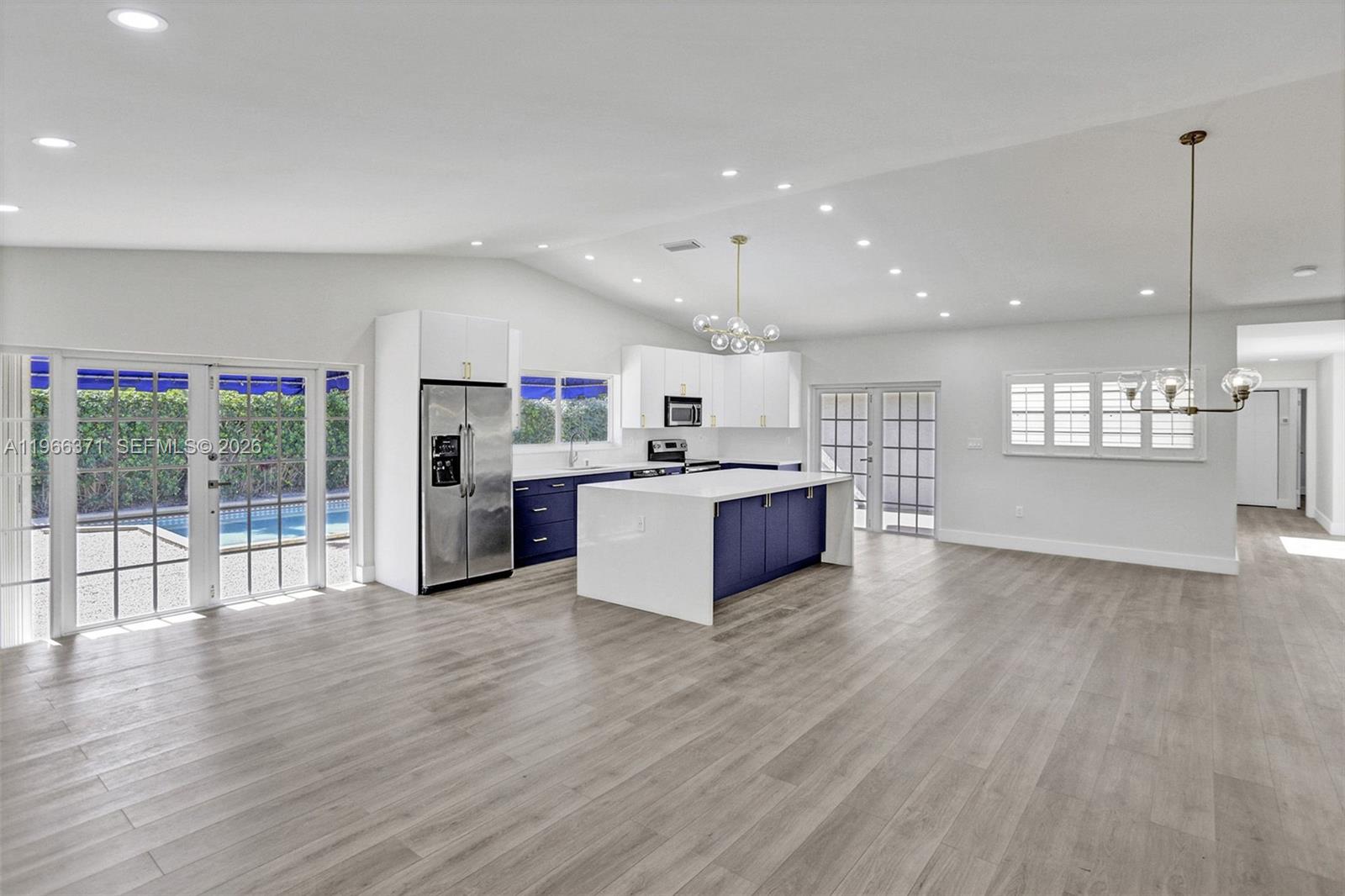 12020 Southwest 93rd Street Miami, FL 33186 - Photo 8 of 42 a large kitchen with stainless steel appliances granite countertop a large center island and a wooden floors