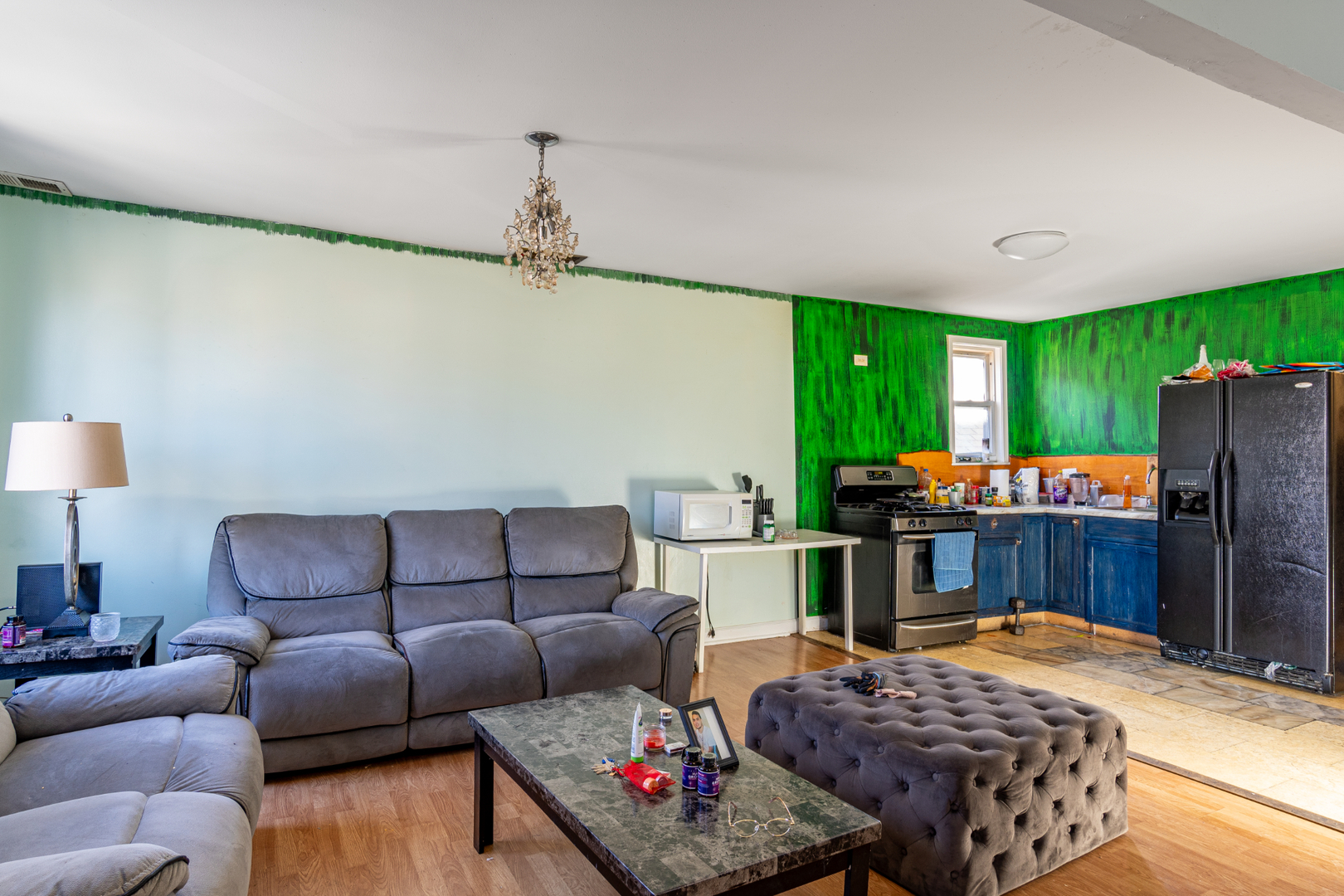 5230 South Justine Street Chicago, IL 60609 - Photo 3 of 15 a living room with furniture and a flat screen tv