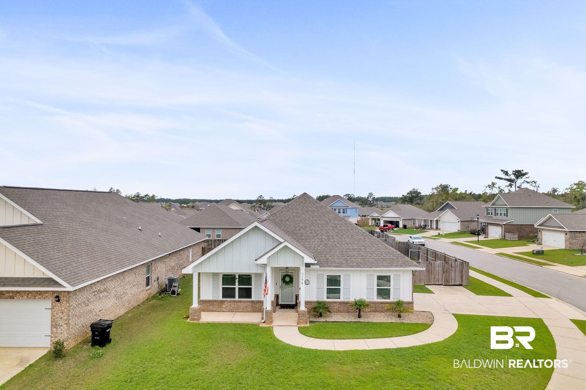 31650 Memphis Loop Daphne, AL 36527 - Photo 53 of 68 View of front of home with board and batten siding, brick siding, a shingled roof, a residential view, and a front lawn