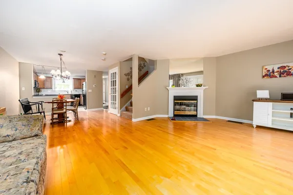 a view of a livingroom with furniture a fireplace and wooden floor