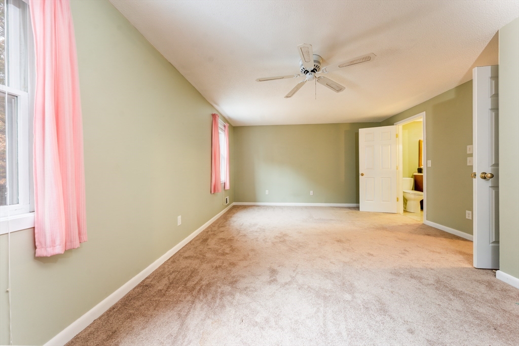 121 S Shellback Way, Unit 121 Mashpee, MA 02649 - Photo 17 of 23 a view of a livingroom with a ceiling fan and window