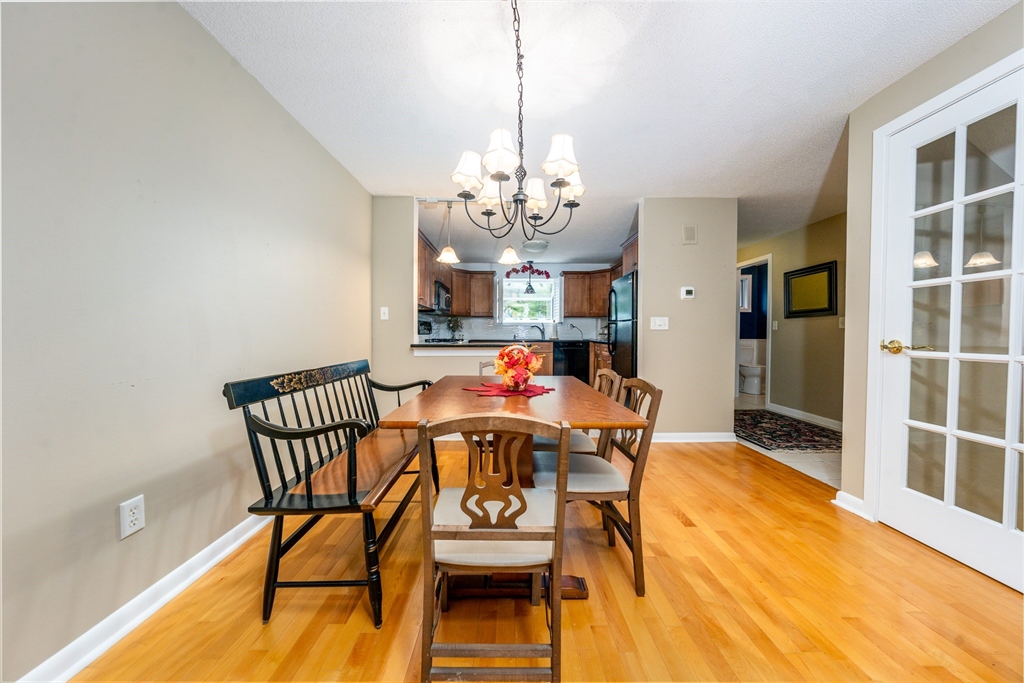 121 S Shellback Way, Unit 121 Mashpee, MA 02649 - Photo 7 of 23 a view of a dining room with furniture and chandelier