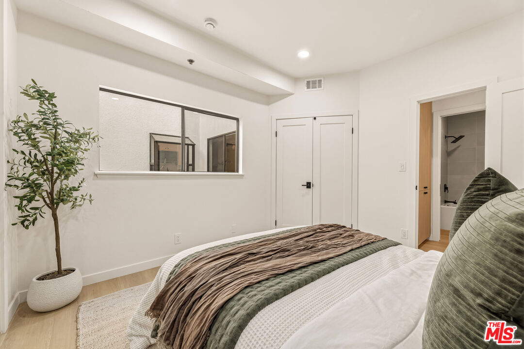 311 Bora Bora Way, Unit 3207 Marina del Rey, CA 90292 - Photo 33 of 54 a bedroom with a bed and a potted plant