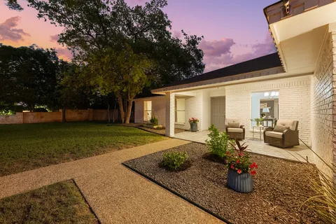 a view of a backyard with chair and tables