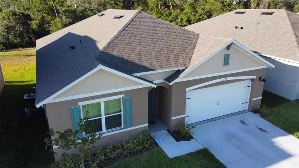 2726 Harmonia Hammock Road Harmony, FL 34773 - Photo 1 of 1 a view of a house with a backyard