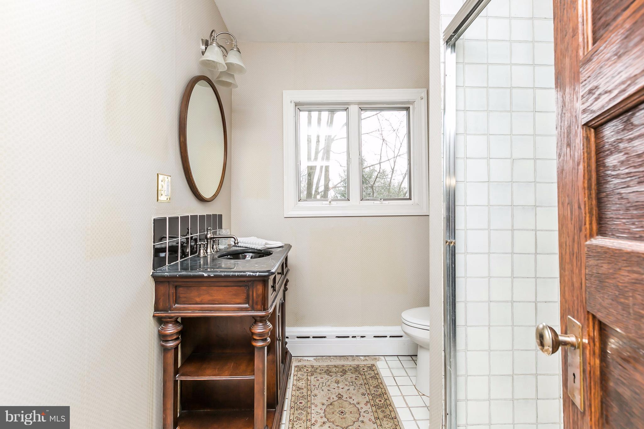 1 Midvale Road Baltimore, MD 21210 - Photo 16 of 30 a bathroom with a toilet a sink and a window